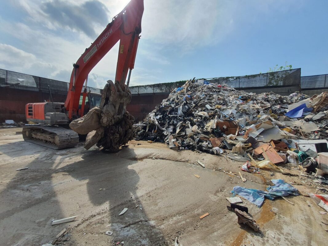 Sorting of  junk disposal with a crane at Waste Disposal @ SG waste management plant in Singapore